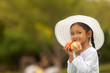 © prasit - portrait of an asian girls eating apples with delicious outdoors