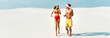 © LIGHTFIELD STUDIOS - panoramic shot of sexy girlfriend and boyfriend in santa hats running on beach in Maldives