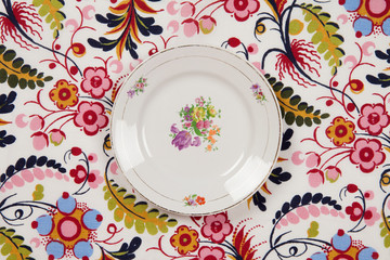 flower plate hidden on a flowery fabric