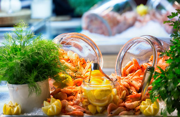 Two big jars with shrimps, greens and lemon