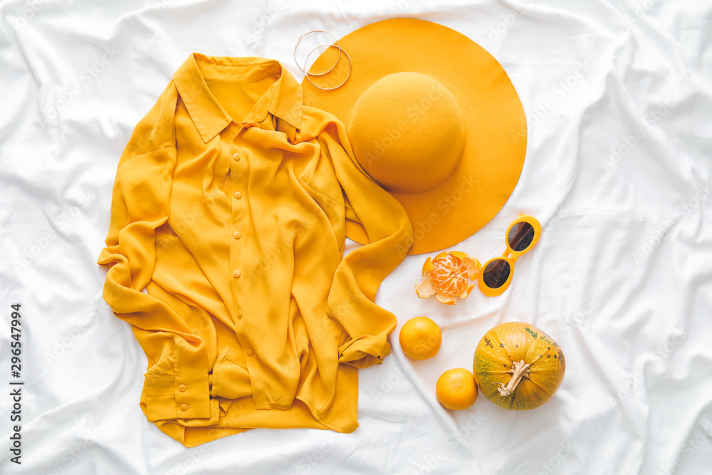 Composition with clothes for autumn weather on white fabric