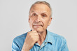 © amixstudio - Portrait of a stylish modern elderly man on a white background in the studio. Senior boss thinking in a pensive pose