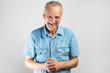 © amixstudio - Gray-haired authentic candid pensioner with a kind face laughs merrily isolated on a white background