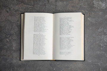 open book on grey stone table, top view