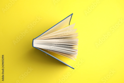 Fotografía Hardcover book on yellow background, top view