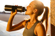 © Drobot Dean - Image of attractive nice woman drinking water while working out