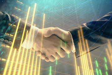 Multi exposure of forex graph on abstract background with two businessmen handshake. Concept of success on stock market