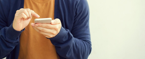 close up man hand holding smartphone to working online on playing social media and application for lifestyle and technology concept