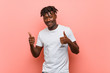 © Asier - Young african black man raising both thumbs up, smiling and confident.