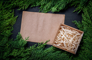 Wall Mural - A frame of fir branches and  gift paper box tied with twine. Christmas card blank.