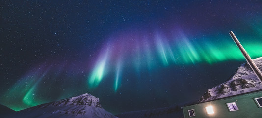 The polar arctic Northern lights hunting aurora borealis sky star in Norway travel photographer  Svalbard in Longyearbyen city the moon mountains