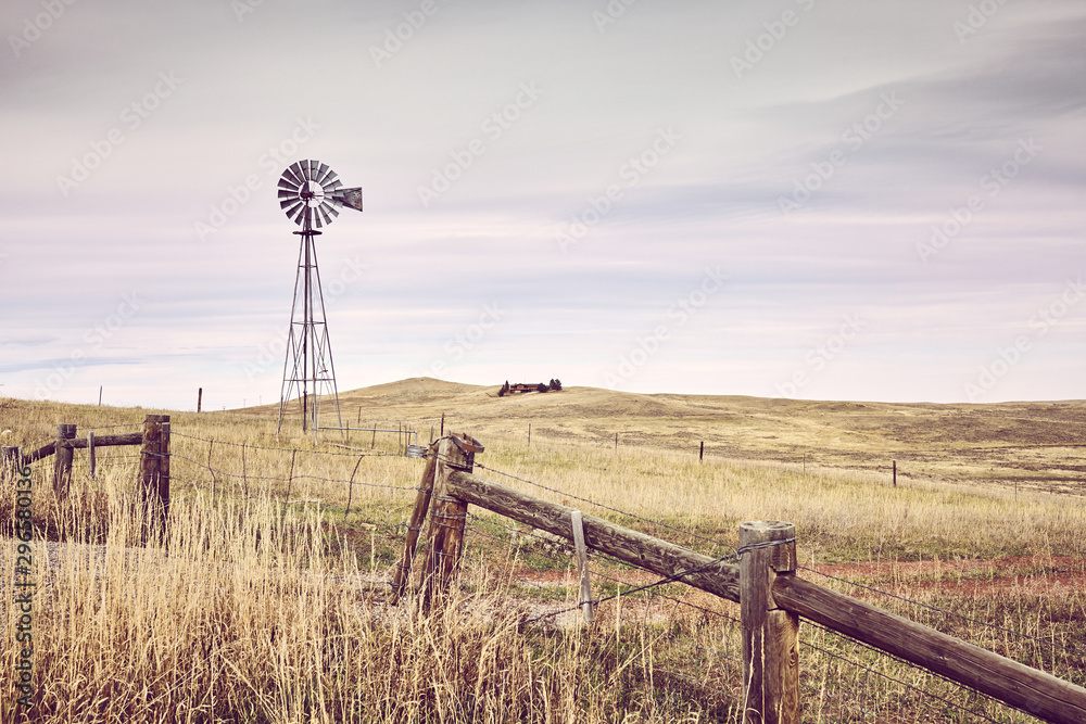 American countryside with an old windmill tower, color toning applied, USA. - obrazy, fototapety, plakaty 