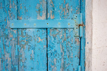 Door Hinge On An Old Wooden Door With Blue Chipped Paint