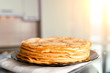 Stack of fresh pancakes on the kitchen table.