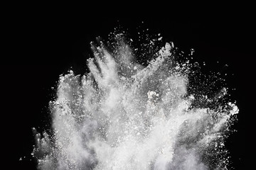 White powder explosion on black background. Colored cloud. Colorful dust explode. Paint Holi.