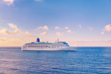 Luxury Cruise Ship Sunset In Blue Sea With Clouds