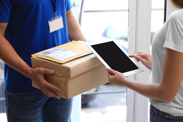 Sticker - Woman using app to confirm delivery of parcel from courier on doorstep, closeup