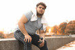 © New Africa - Young overweight man with towel resting in park