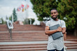 © AS Photo Family - African student male posed with backpack and school items on yard of university, against flags of different countries.