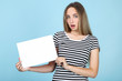 © 5second - Beautiful young woman holding white blank board on blue background