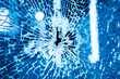 canvas print picture - Broken glass window. Blue background. Closeup.