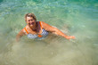 Mature plump woman bathing in the sea