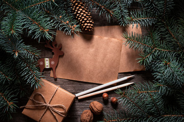 Wall Mural - A frame of fir branches and  gift paper box tied with twine. Christmas card blank.