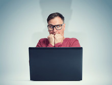 Scared Man With Glasses In Front Of Laptop. Fear Emotion Concept