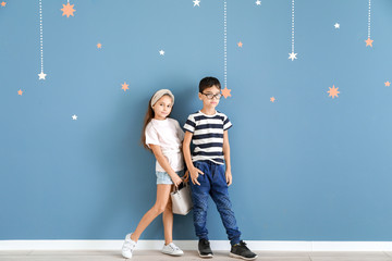 Wall Mural - Cute fashionable children near color wall