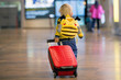 © Tomsickova - Cute  baby boy waiting boarding to flight in airport transit hall near departure gate. Active family lifestyle travel by air with child