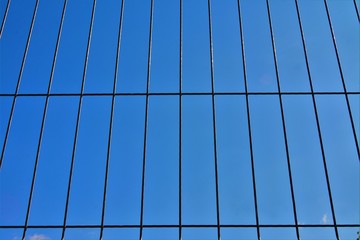 blue sky viewed by a metal fence