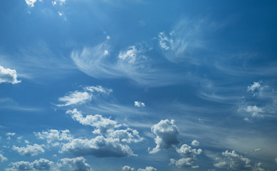 Some light cumuliform and cirrus clouds in the clean blue sky.