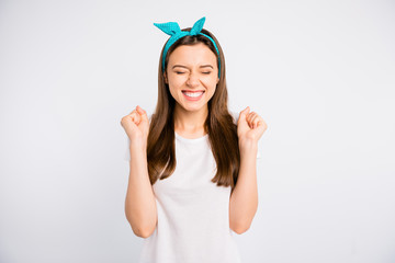 Poster - Portrait of ecstatic girl with her eyes closed raise fists wait for her present on birthday anniversary wear casual style isolated over white color background