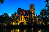 Fototapeta Nowy Jork - Germany, Popular stuttgart feuersee church of st john gothic building illuminated by night in downtown reflecting in water of lake