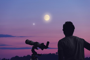 Wall Mural - astronomer with a telescope watching at the stars and moon. my astronomy work.