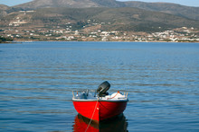Greece – A Red Row Boat Moored. The Island Of Antiparos In The Aegean Sea.