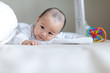 Adorable baby boy doing tummy time on bed