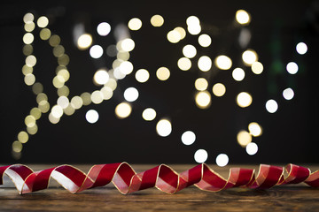 Swirling ribbon near blurred garland