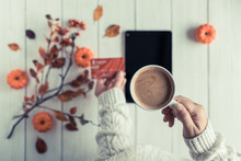 Woman With Tablet And Credit (discount) Card Cup On White Retro Wood Boards. Coffee, Tablet, Leaves, Rowan And Small Pumpkins . Autumn, Fall Concept. Flat Lay, Top View.