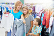 © Sergey Ryzhov - Mother with children in clothing store