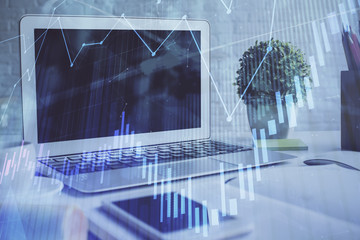 Stock market graph and table with computer background. Double exposure. Concept of financial analysis.