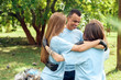 © Viktoriia - Volunteering. Young people volunteers outdoors hugging smiling cheerful teamwork
