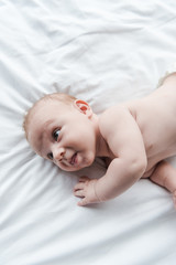 Wall Mural - top view of adorable infant baby lying on bed at home