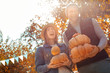 © Viktoriia - Young adult friends laughing and holding ripe pumpkin in hands