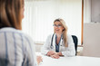 © bnenin - Portrait of a smiling female doctor with a patient in the office.