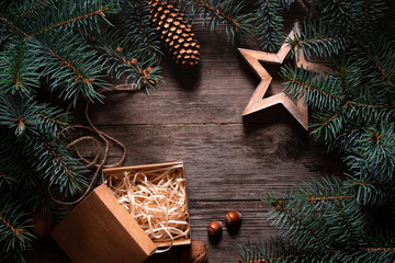 Wall Mural - A frame of fir branches and an open gift paper box tied with twine. Christmas card blank.