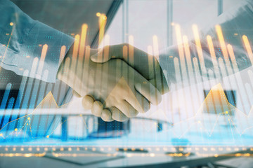 Multi exposure of financial graph on office background with two businessmen handshake. Concept of success in business