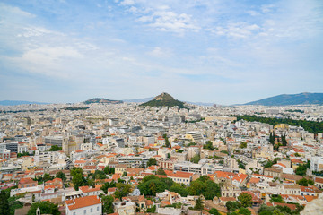 Canvas Print - Urban Athens spreading out below with landmark Mount Lycabettus in centre of image