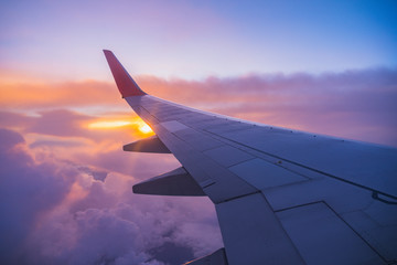 beautiful sunset, sky on the top view, airplane flying view from inside window aircraft of traveling