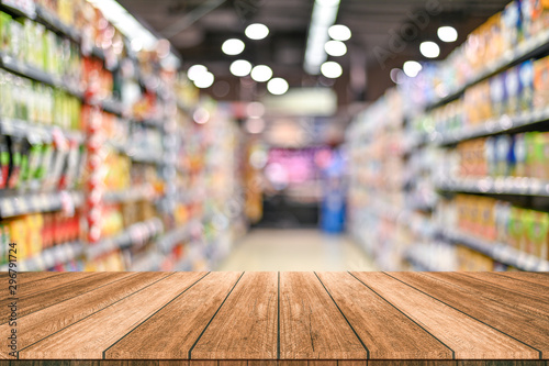 Fotomural Empty top wooden table with supermarket blur background